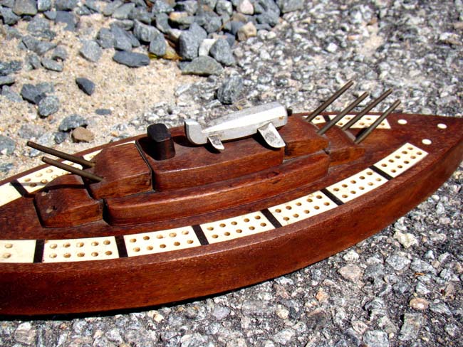 Possibly unique early 20th century bone inlaid cribbage board in the form of a Battleship with deck mounted plane. — image 2